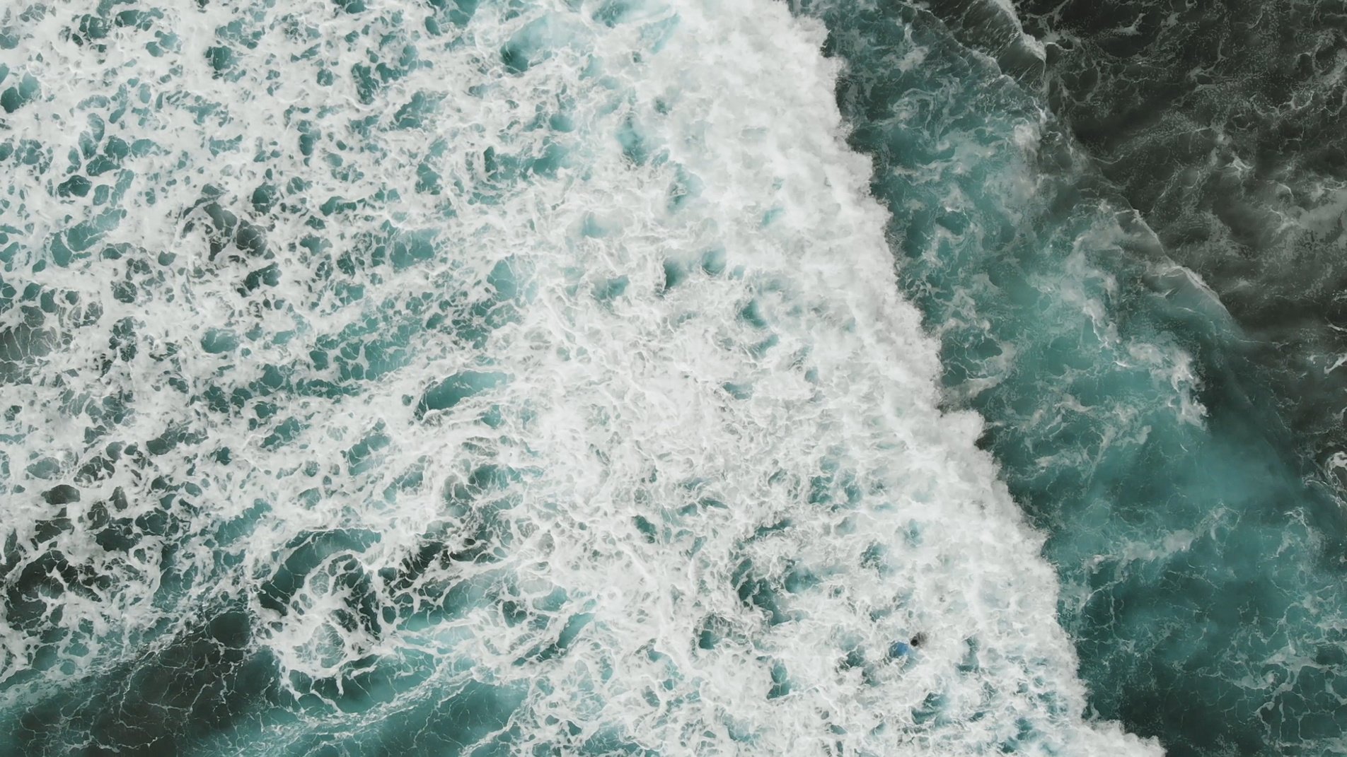 A view from the drone to the stunning turquoise ocean and the big waves with sea foam. Atlantic, Spain